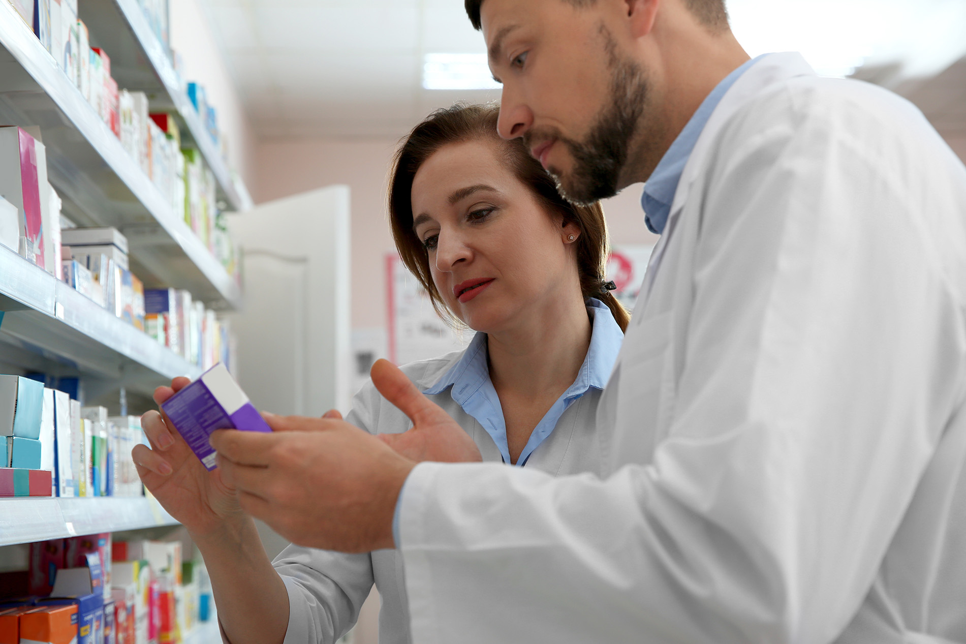 Pharmacist showing customer an OTC Drug