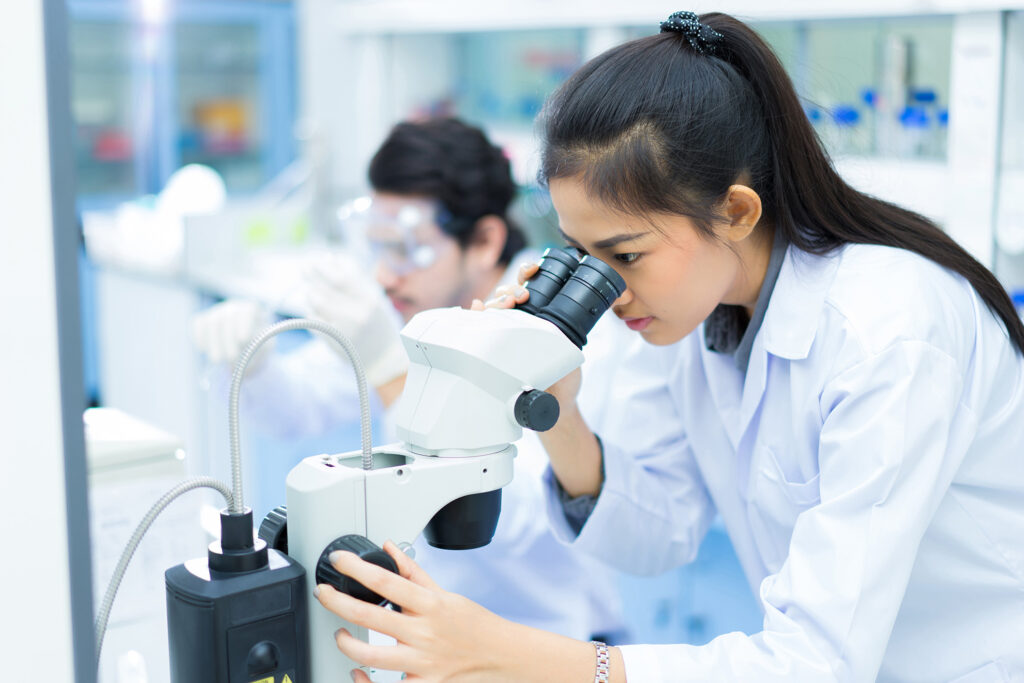Female lab tech examining an OTC drug formulation for testing